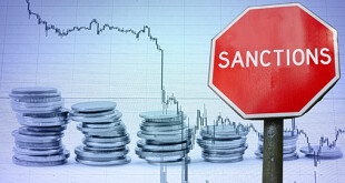Sanctions sign against economy background with graph and coins.