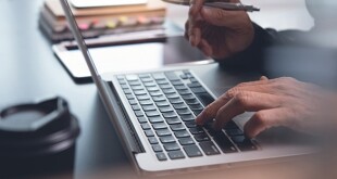 Home office, online working, E learning concept. Businessman typing on laptop computer. Man browsing internet at home. Student studying online class with pen, book, digital tablet on desk, close up