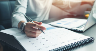 Business woman sitting working and thinking to planner event with calendar and laptop, computer on table at office or home or internet cafe.